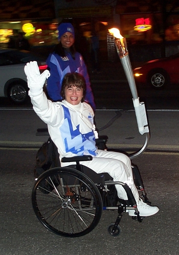 Rosemarie Rossetti carrys the 2002 Winter Olympic Torch in front of The Ohio State University