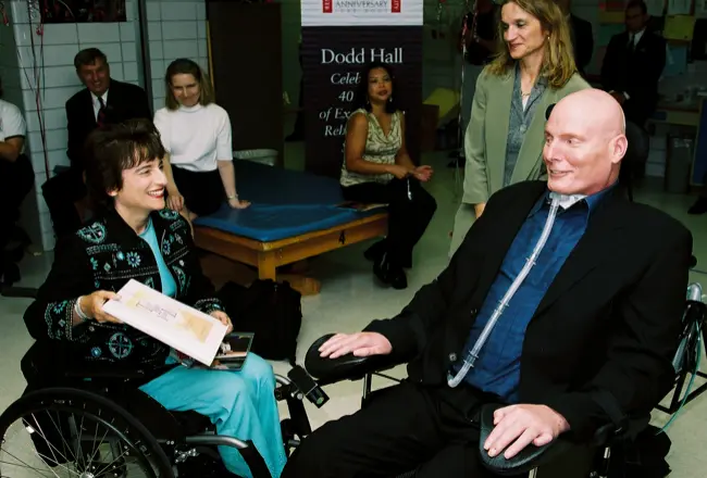 Rosemarie Rossetti, Ph.D. shows a copy of 'Take Back Your Life' to Christopher Reeve