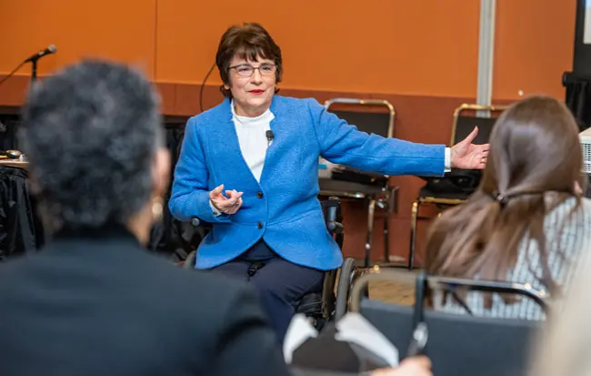 Rosemarie Rossetti asking a question of hotel lobby guest services representative